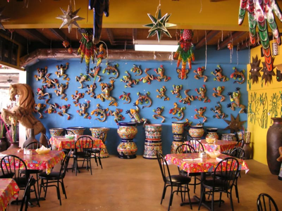 A creatively decorated wall lets diners know that this is a fun place to eat, or possibly that management has been into the mescaline again.
